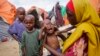 Maryan Madey, who fled the drought-stricken Lower Shabelle region, holds her malnourished daughter Deka Ali, 1, at a camp for the displaced on the outskirts of Mogadishu, Somalia, Sept. 3, 2022. 