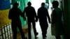 FILE - Residents walk along a corridor after lunch time in a facility for people with mental and physical disabilities in the village of Tavriiske, Ukraine, May 10, 2022. 