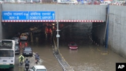 A highway is clogged with water near the Indira Gandhi International Airport after heavy rains in New Delhi, India, June 28, 2024.