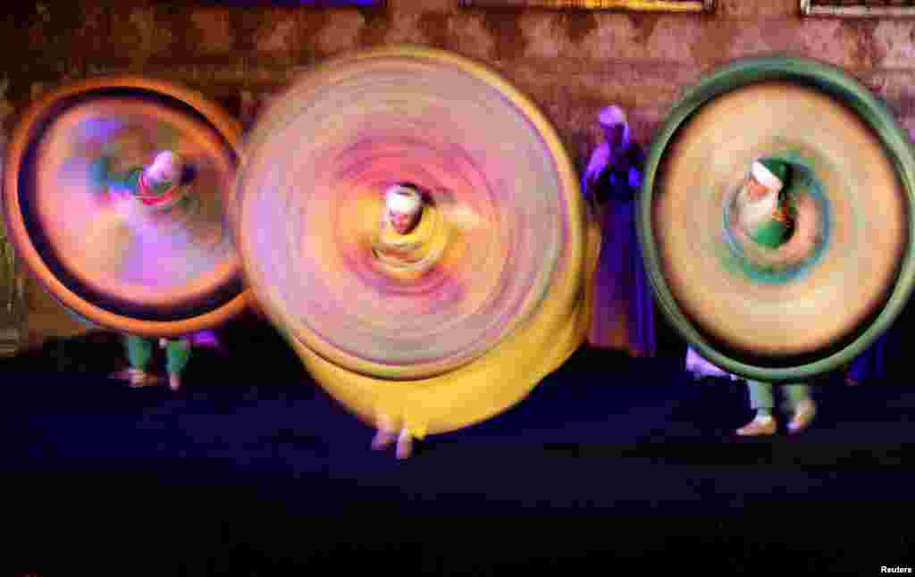 Traditional dancers perform the Tanoura, an Egyptian version of the Sufi dance, during the holy fasting month of Ramadan, at Al Ghouri Palace in the old Islamic area of Cairo, April 12, 2023. 
