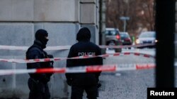 Members of the police stand guard following a shooting at one of Charles University's buildings in Prague, Czech Republic, Dec. 22, 2023.
