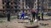 FILE - Police investigators inspect a body near an apartment complex hit in a Russian missile strike in Kryvyi Rih, Ukraine, June 13, 2023. 