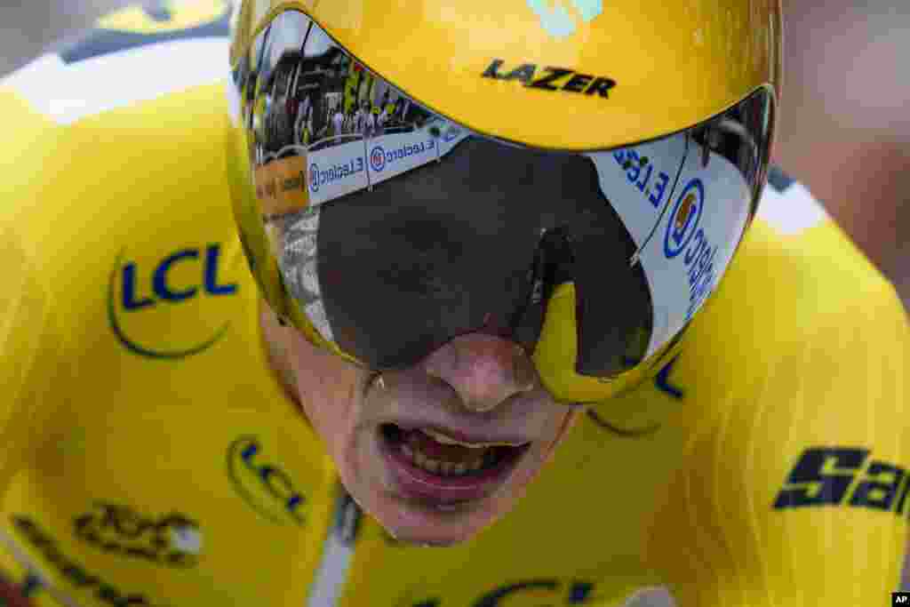 Stage winner and overall leader Denmark's Jonas Vingegaard strains during the 16th stage of the Tour de France cycling race, an individual time trial over 22.5 kilometers, with the start in Passy and the finish in Combloux, France.