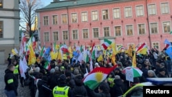 Protesters celebrate the guilty verdict of Hamid Noury in Stockholm, Sweden, Dec. 19, 2023.
