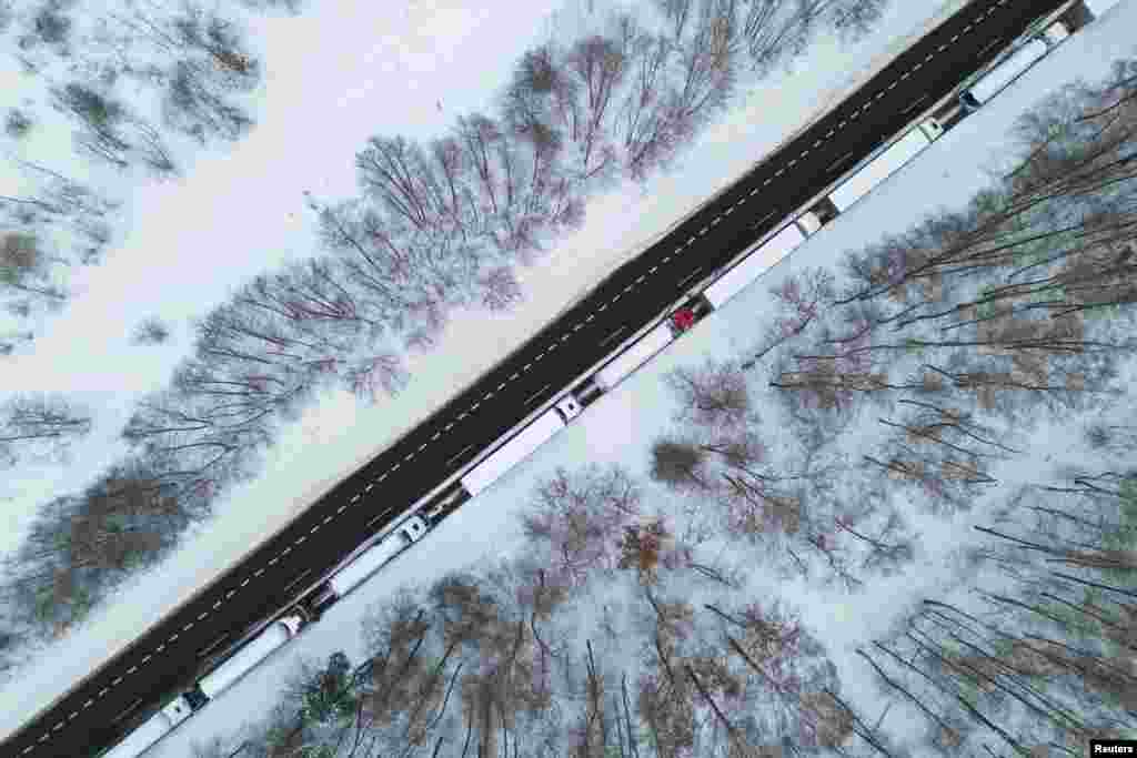 Trucks line up in a long queue to cross the Polish-Ukrainian border at the Dorohusk-Jagodzin crossing, in Ludwinow, Poland, Dec. 4, 2023. 