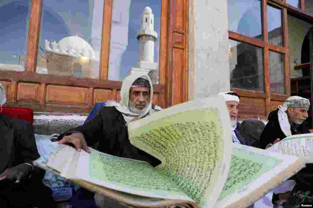 People read the Koran at the Grand Mosque ahead of the fasting month of Ramadan in Sanaa, Yemen, March 22, 2023. 