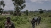 Waasi wa kundi la M23 wakilinda eneo hilo wakati wa mkutano kati ya maafisa wa Kikosi cha Afrika Mashariki (EACRF) na waasi wa M23 katika kambi ya Rumangabo huko DRC Januari 6, 2023. Picha na Guerchom Ndebo/AFP