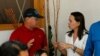 FILE - Milciades Avila, security chief for opposition leader Maria Corina Machado, talks with her in Maturin, Venezuela, March 28, 2023. 
