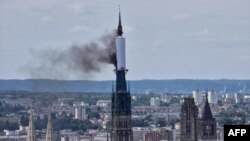 Smoke billows from the spire of Rouen Cathedral in Rouen, northern France on July 11, 2024. 