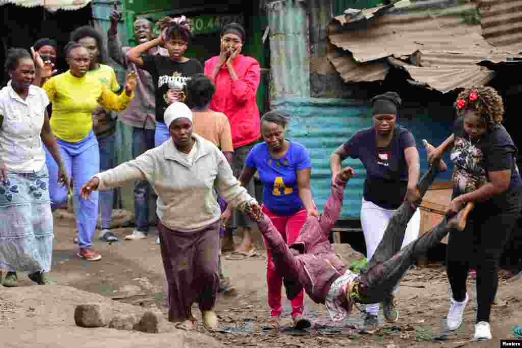 Women carry a supporter of Kenya's opposition leader Raila Odinga, who was shot during a protest of the government over the imposition of tax hikes, at the Mathare settlement in Nairobi.