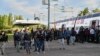 FILE - French Police prevent migrants from boarding a train at des Fontinettes railway station in a new policing strategy to hinder clandestine crossings of the Channel, in Calais, northern France on April 29, 2024.