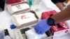 FILE - Syringes with vaccines are prepared at the L.A. Care and Blue Shield of California Promise Health Plans' Community Resource Center where they were offering members and the public free flu and COVID-19 vaccines Oct. 28, 2022, in Lynwood, Calif. 