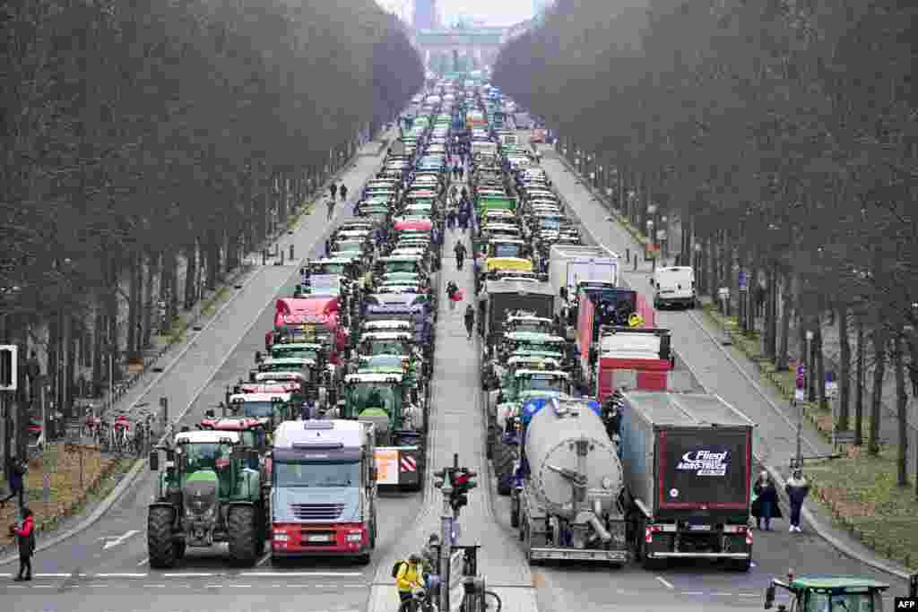Tractors are lined up in the &quot;Strasse des 17 Juni&quot; boulevard, towards the Brandenburg Gate in Berlin, as German farmers demonstrate against the planned abolition of subsidies for agricultural diesel.