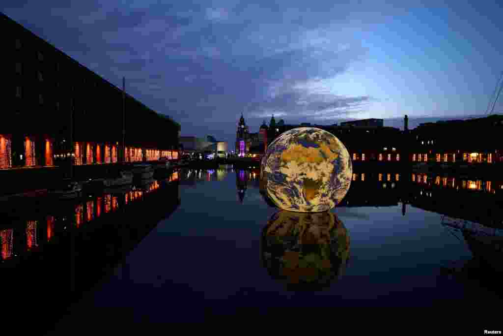 Luke Jerram&#39;s &#39;Floating Earth&#39;, an art installation as part of the Eurovision celebrations is seen in the Albert Dock in Liverpool, Britain.