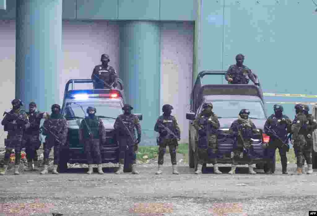 Members of the Mexican police take up positions in a show of force under a bridge that connects the U.S. and Mexico, as seen from Eagle Pass, Texas.&nbsp;The U.S. will officially end on May 11 its 40-month COVID-19 emergency, and the Title 42 law, a tool that has been used to prevent millions of migrants from entering the country.