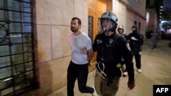 Policija privodi jednog od demonstranata na univerzitetu Columbia.