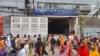 Garment workers break for lunch during work hours, in Dhaka on July 24, 2024. Garment factories and banks reopened in Bangladesh after authorities eased a curfew imposed to contain deadly clashes sparked by student protests. 
