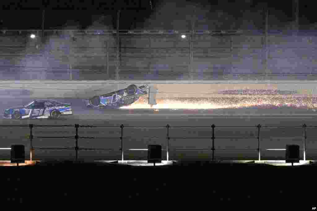 Sam Mayer&#39;s car slides on its roof along the back stretch after a collision on the final lap of the NASCAR Xfinity Series auto race at Daytona International Speedway, Feb. 18, 2023, in Daytona Beach, Florida.