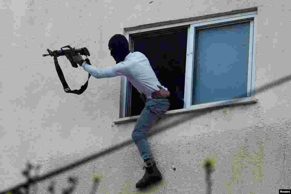 Palestinians clash with Israeli troops during an Israeli army raid in Jenin in the Israeli-Occupied West Bank.