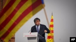 Catalan independence leader and former President Carles Puigdemont addresses supporters after his arrival near the Catalan parliament to attend the investiture debate in Barcelona, Spain, Aug. 8, 2024.