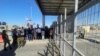 Right-wing protesters wave Israeli flags outside Sde Teiman detention facility, after Israeli Military Police arrived at the site as part of an investigation into suspected abuse of a Palestinian detainee, near Beersheba in southern Israel, July 29, 2024.