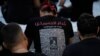 A supporter of the Iranian-backed Hezbollah group wears a T-shirt with pictures of Hezbollah fighters killed in battles with Israel, during activities marking the Shiite Muslim holy day of Ashoura, in suburban Beirut, Lebanon, July 17, 2024.