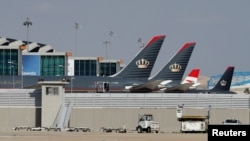FILE - Planes that belong to the Royal Jordanian Airlines and other companies are parked at the Queen Alia International Airport in Amman, Jordan, Feb. 23, 2020. Jordan has asked on Aug. 5, 2024, all airlines landing at its airports to carry 45 minutes of reserve fuel.