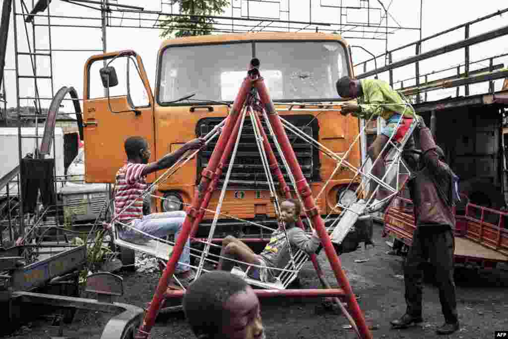 Young boys play on a swing made out of scrap metal underneath a makeshift platform called Kolas Space in the popular Ndjili neighborhood in Kinshasa.