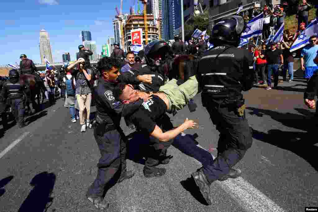 Israeli police officers detain a demonstrator during &quot;Day of Resistance&quot;, as Prime Minister Benjamin Netanyahu&#39;s nationalist coalition government presses on with its contentious judicial overhaul, in Tel Aviv.