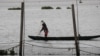 FILE - A Filipino fisherman casts his net to fish in Laguna de Bay in Muntinlupa, Metro Manila, Philippines, October 30, 2018. 