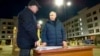 Russian President Vladimir Putin, right, listens to Russian Deputy Prime Minister Marat Khusnullin at a newly built neighborhood during their visit to Mariupol in Russian-controlled Donetsk region, Ukraine, March 19, 2023.