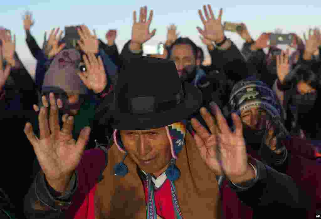 Aymara Indigenous people receive the first rays of sunlight in a New Year&#39;s ritual on the sacred mountain Apacheta Murmutani on the outskirts of Hampaturi, Bolivia.&nbsp;Aymara Indigenous communities are celebrating the Andean new year 5,531 or &quot;Willka Kuti,&quot; that translates to return of the sun, in Aymara.