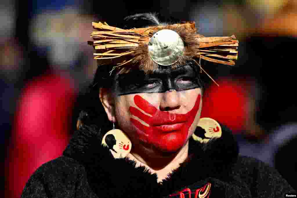People march through the Downtown Eastside for the 32nd annual Women&#39;s Memorial March, honoring missing and murdered Indigenous women in Vancouver, British Columbia, Canada, Feb. 14, 2023.
