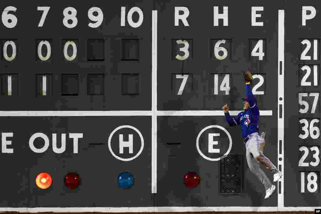 Toronto Blue Jays&#39; Daulton Varsho makes the catch on the fly out by Boston Red Sox&#39;s Enmanuel Valdez during the eighth inning of a baseball game, May 3, 2023, in Boston, Massachusetts.