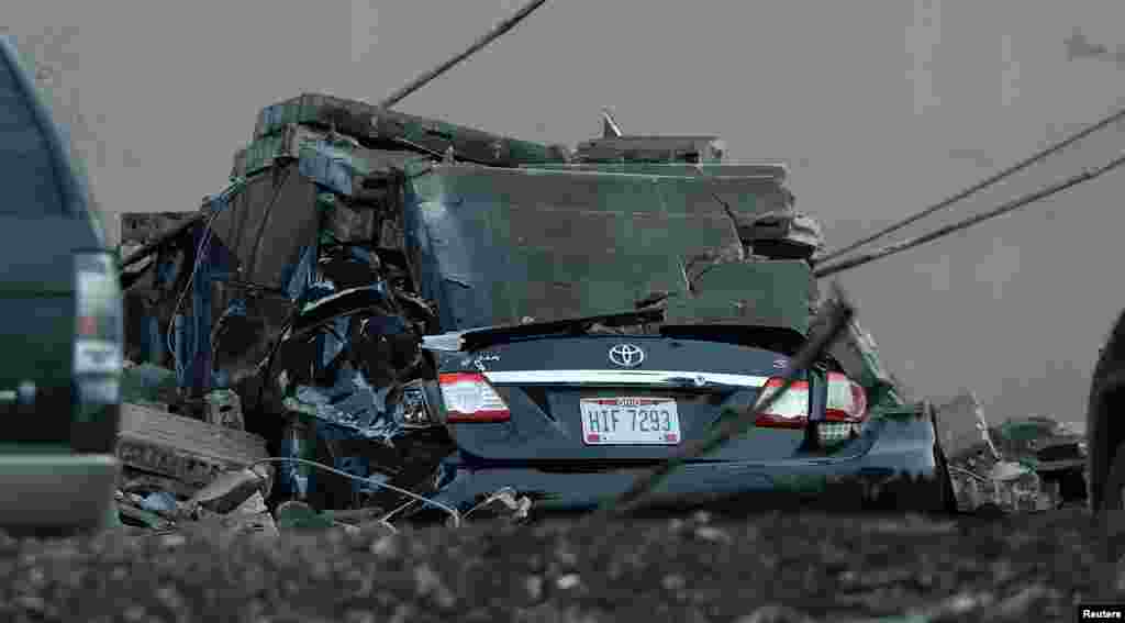 A vehicle is destroyed by a brick wall that fell from the I&nbsp; Schumann &amp; Co. metals plant after an explosion at the factory in Bedford, Ohio.