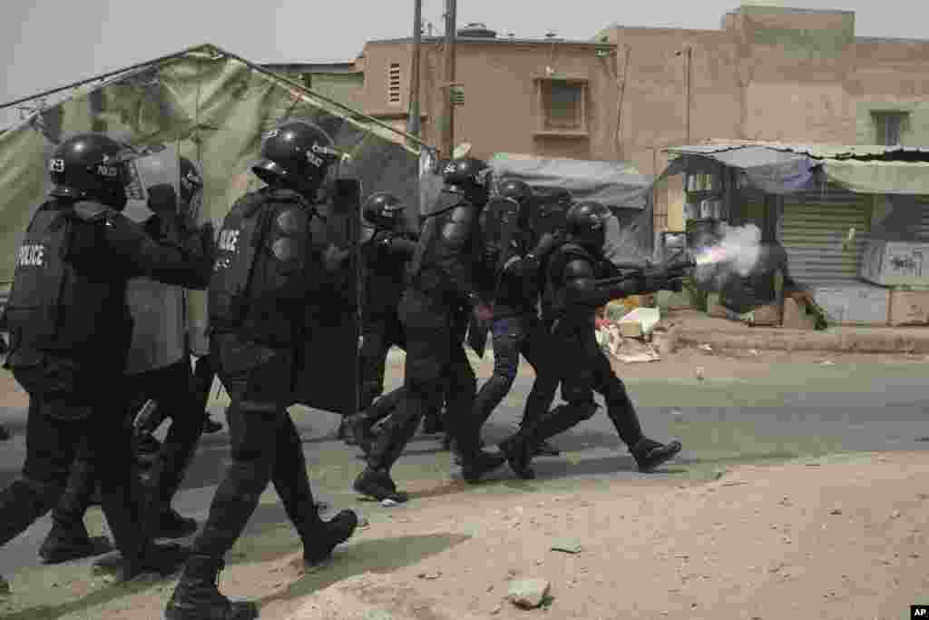 A riot police officer fires tear gas at supporters of the opposition leader&#39;s Ousmane Sonko after he left the tribunal in Dakar, Senegal.