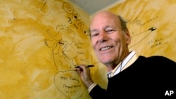 FILE - Babar author Laurent de Brunhoff signs the wall, while celebrating 75 years of the book, April 21, 2006 at Mabel's Fables in Toronto.