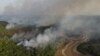 FILE - Smoke billows from a wildfire during a drought in the Amazon rainforest near a dry river in Iranduba, Amazonas state, Brazil September 25, 2023.
