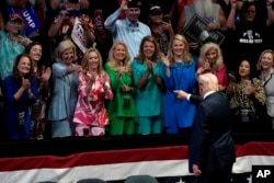 Republikanski predsjednički kandidat bivši predsjednik Donald Trump pozdravlja pristalice na odlasku nakon govora na predizbornom događaju u Grand Rapidsu, Michigen, 20. jula 2024.
