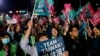 台湾民进党支持者1月13日挥舞“Team Taiwan,挺台湾”的旗帜，等候选举结果的揭晓