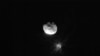 FILE - View of Didymos, Dimorphos, and the plume coming off of Dimorphos after the Double Asteroid Redirection Test, or DART mission, purposefully made impact, in this image by ASI's LICIACube satellite, Sept. 26, 2022. (ASI/NASA/Handout via Reuters)