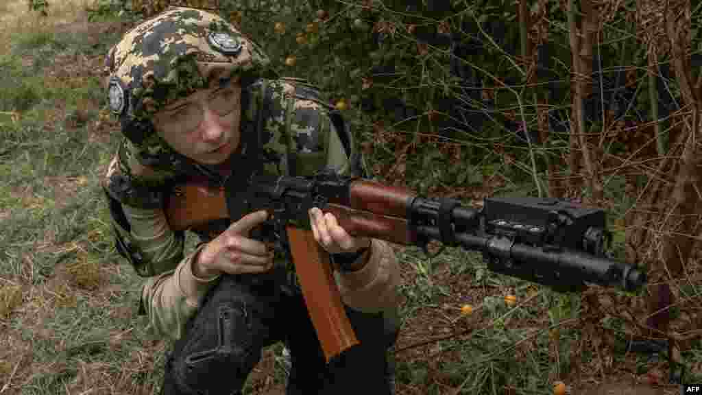 A participant takes part in a training during her five days of national resistance military training for civilians, in Kyiv, Ukraine.