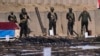 FILE - The Popular Mobilization Forces display weapons seized from Islamic State militants in Salahuddin province, north of Baghdad, Iraq, Jan 12, 2023. A U.S. strike killed four PMF members in Iraq on Tuesday. 