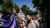 A demonstrator gestures as he holds a flag during the LGBT Pride Parade in the Kadikoy district to celebrate the Pride Month in Istanbul, June 30, 2024. Turkish police detained at least 15 protesters in Istanbul on Sunday for participating in the rally.