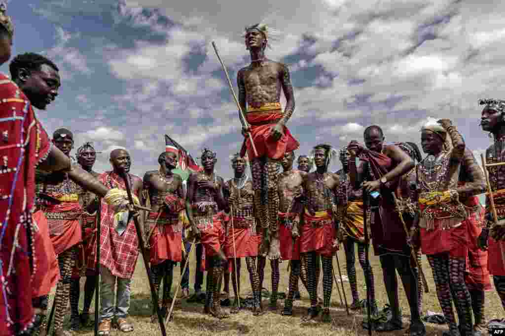 A group of Maasai men perform their traditional jumping dance during a Maasai cultural festival in Sekenani, Kenya, June 10, 2023. 