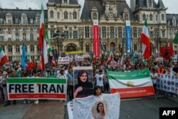 Demonstrators attend a protest against the Iranian regime in front of the Hotel de Ville in Paris on Sept. 16, 2023, on the first anniversary of the death of Mahsa Amini in Iran.