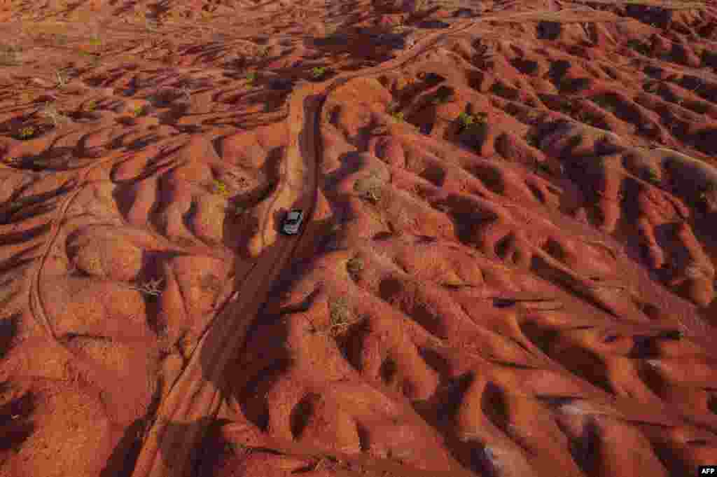 Aerial view showing a car riding along a dirt road in the Desert of Gilbues, in Gilbues, in the northeastern state of Piaui, Brazil, Sept, 30, 2023.&nbsp;Gilbues is Brazil&#39;s worst desertification hotspot, where a parched, canyon-pocked landscape is swallowing up farms and residences. Experts say the phenomenon is caused by rampant erosion of the region&#39;s naturally fragile soil, exacerbated by deforestation, reckless development and probably climate change.