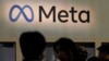 FILE - Attendees visit the Meta booth at a conference in San Francisco, California, March 22, 2023.