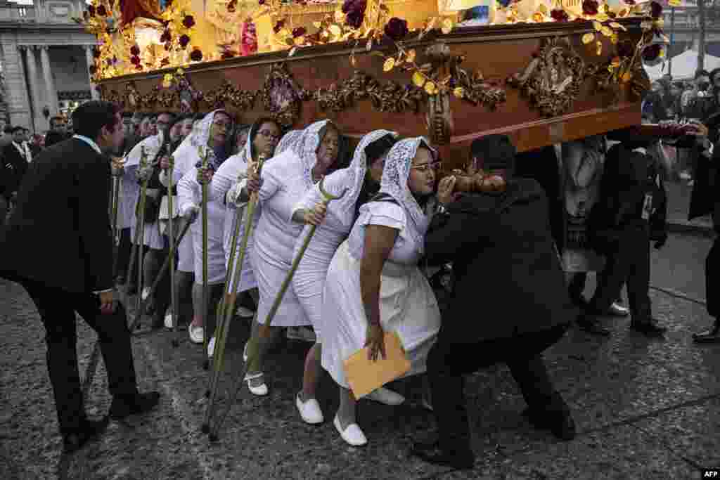 Pilgrims participate in the procession of the Virgin of the Poor of the Temple of San Francisco in Guatemala City, Jan. 13, 2024.