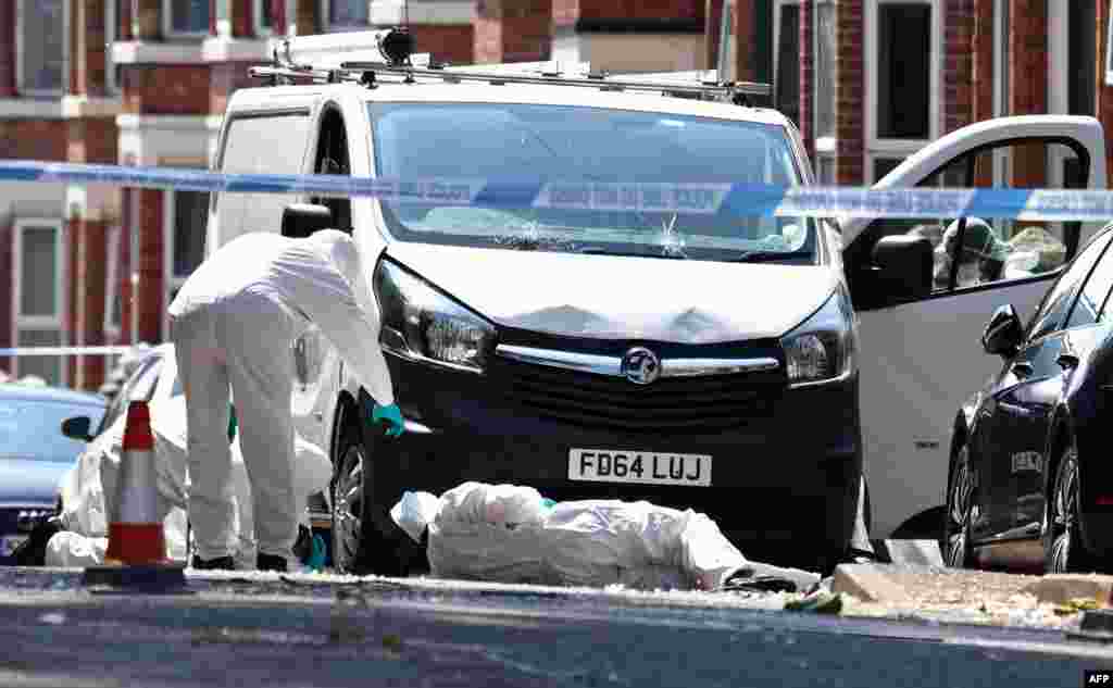 Forensics officers work at the scene of a &quot;major incident&quot; in which three people were found dead&nbsp;on Bentinck Road in Nottingham, England.&nbsp;Police arrested a suspect in the deaths and who they say might be involved in trying to run over three other people in Nottingham.